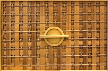 Close up of beautiful brown synthetic rattan texture with round wooden handle. Suitable for drawers...