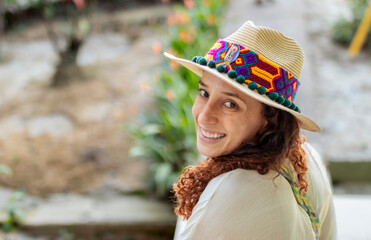 Cute woman with a Curly red haired girl smiling at the camera wearing a handcrafted latin hat