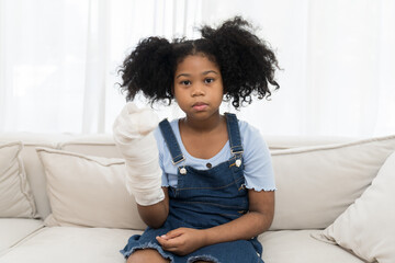 Health care and patient in hospital. African American little child girl have an accident and...