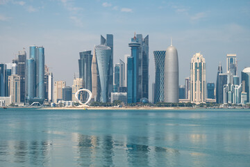 Fototapeta premium Panoramic view of the tall skyscrapers of Doha in Qatar. Persian Gulf countries. Doha skyline view with sea