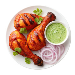 Grilled Chicken Drumsticks with Green Chutney and Sliced Onions on a White Plate