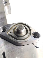 Close up view of precisely machined metal component with circular grooves and mounting holes