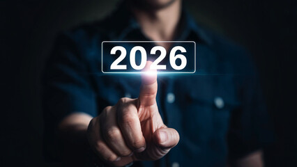 Man s finger activating the year 2026 on a futuristic digital interface with glowing light