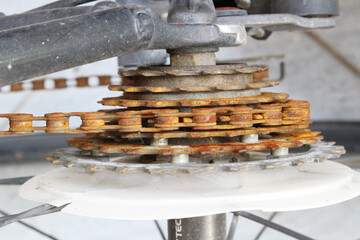 Heavily rusted bicycle sprockets and chain, clearly depicting severe wear and neglect due to lack...