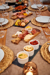 Elegant charcuterie board with assorted cheeses and meats on rustic table setting