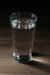 Fresh water in glass on wooden table, closeup