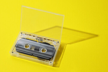 Obraz premium One audio cassette in open box on yellow background