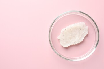 Cosmetic product in Petri dish on pink background, top view. Space for text