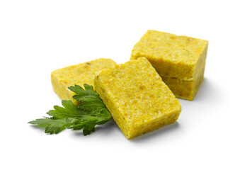 Tasty aromatic bouillon cubes and parsley isolated on white