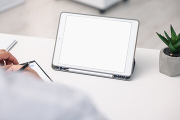 Doctor having online consultation via tablet in clinic, closeup