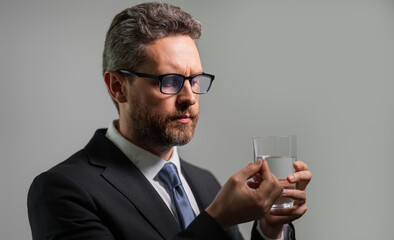 Medicine pill from headache migraine. Man with headache on isolated gray studio background. Man feel pain rubbing dry eyes fatigued from work.