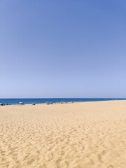 deck chairs and umbrellas on the sea beach in summer