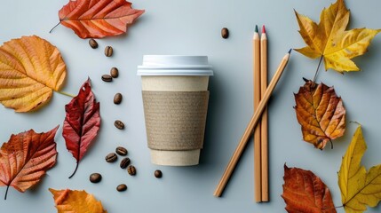 Flat lay of a takeaway coffee cup, autumn leaves, coffee beans, and wooden pencils on a clean surface, capturing cozy fall vibes and eco-friendly minimalism
