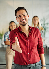 Obraz premium Portrait of a group of business people having a meeting in the office. Teamwork and success concept, portrait of a young businessman offering hand for a handshake, greeting and introducing