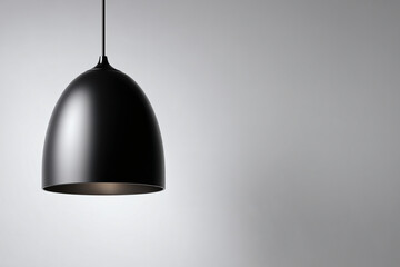 Black pendant light fixture with a smooth, dome-shaped shade against a light gray background.