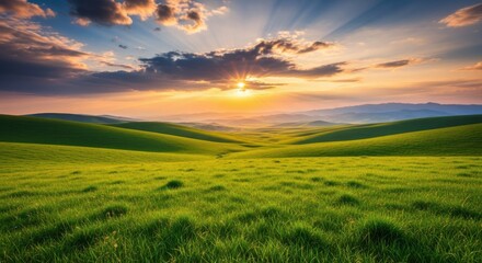 Obraz premium Beautiful Sunrise Over Rolling Green Hills and Dramatic Clouds