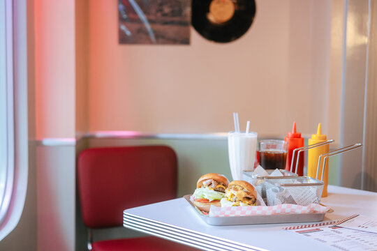 Classic Diner Cheeseburgers with Fries and Drinks