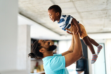 Portrait of father and son having fun at home in bedroom, family life, parenting, love and bonding...
