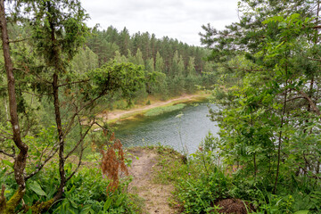 Forest Lake View with Wooden Structures on Sandy Bank