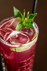 Refreshing berry mocktail with mint leaves and ice in a glass