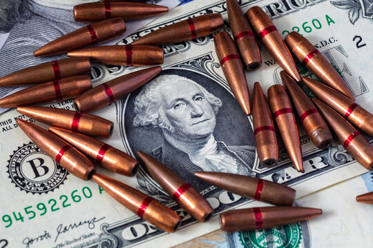 Background with American dollars and bullets from a machine gun. Global world crisis and world war