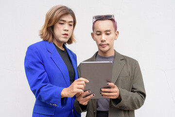 Gender inclusive business team couple against white background