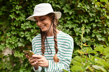 Enjoying a sunny day at the park while texting friends during a picnic