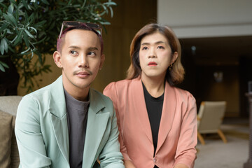 Transgender and non-binary coworkers working remotely in cafe