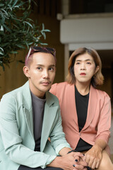 Transgender and non-binary coworkers working remotely in cafe