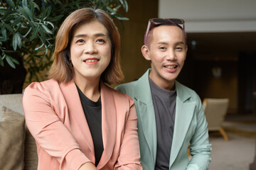 Transgender and non-binary coworkers working remotely in cafe