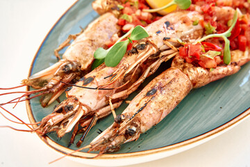 Grilled shrimp with fresh salsa on a green serving plate: a seafood delight