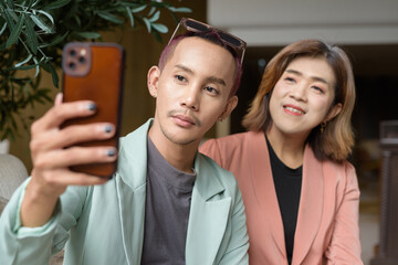 Transgender and non-binary coworkers working remotely in cafe