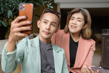 Transgender and non-binary coworkers working remotely in cafe