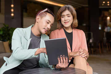 Transgender and non-binary coworkers working remotely in cafe