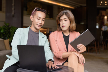 Transgender and non-binary coworkers working remotely in cafe