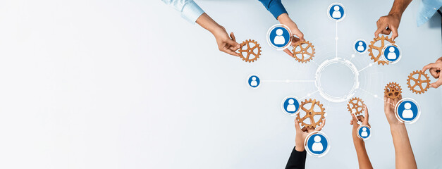 This image illustrates hands connecting gears, symbolizing teamwork and networking among...