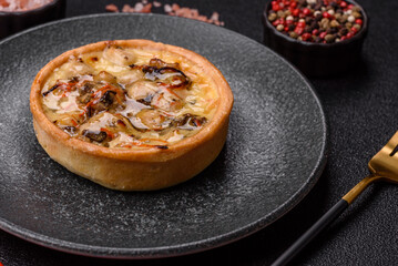 Pie or quiche, a sour tart with chicken and mushrooms, spices and herbs. Round quiche with chicken