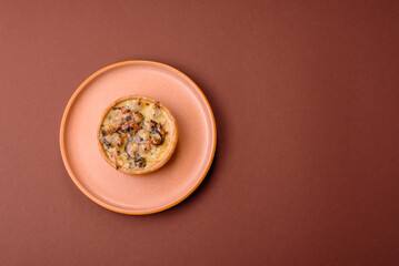 Pie or quiche, a sour tart with chicken and mushrooms, spices and herbs. Round quiche with chicken