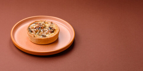 Pie or quiche, a sour tart with chicken and mushrooms, spices and herbs. Round quiche with chicken