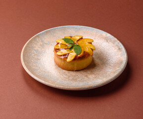 Sweet round pie or tart with apples and peach. Mini sweet tart