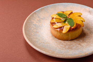 Sweet round pie or tart with apples and peach. Mini sweet tart