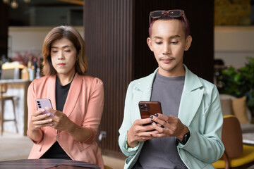 Transgender and non-binary coworkers working remotely in cafe