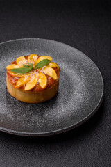 Sweet round pie or tart with apples and peach. Mini sweet tart