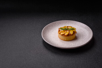 Sweet round pie or tart with apples and peach. Mini sweet tart