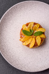 Sweet round pie or tart with apples and peach. Mini sweet tart