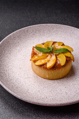Sweet round pie or tart with apples and peach. Mini sweet tart