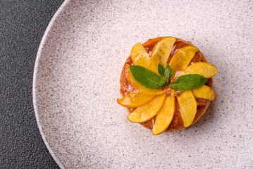 Sweet round pie or tart with apples and peach. Mini sweet tart