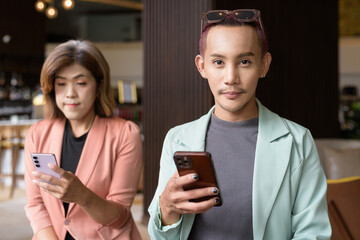 Transgender and non-binary coworkers working remotely in cafe
