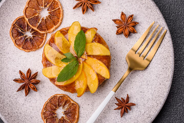 Sweet round pie or tart with apples and peach. Mini sweet tart