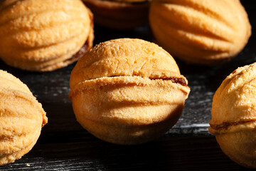 walnut shaped cookies on black wood background